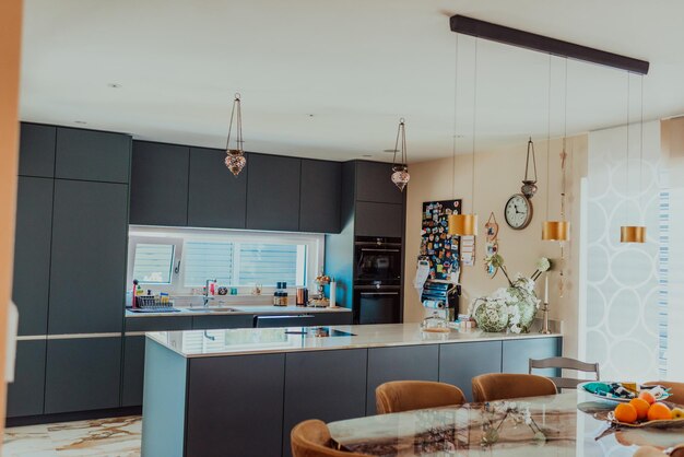 Modern gray kitchen with electronic devices and decorative items