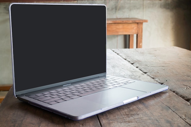 Modern grey metal laptop on wooden table