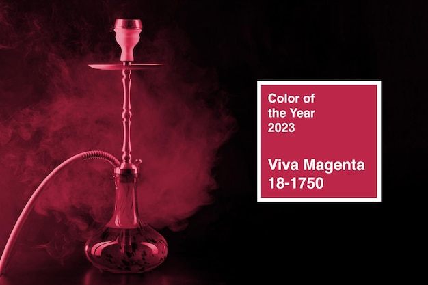 Modern hookah with smoke in dark club light Color of the year 2023 viva magenta