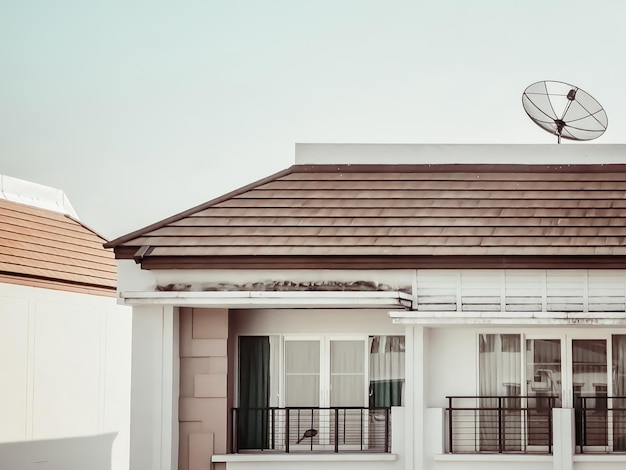 Modern house on clear sky background. Modern and new apartment building. and Satellite dish attached on the roof