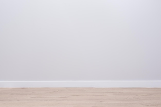 Modern interior of an empty apartment, gray walls, wooden floor.