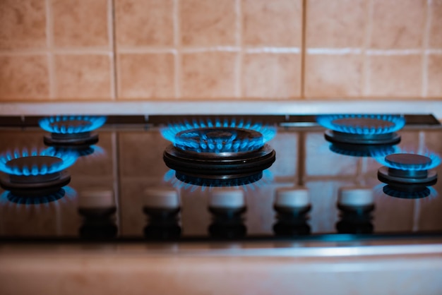 Modern kitchen stove cook with blue flames burning