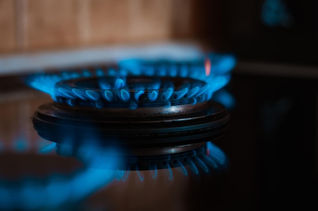 Modern kitchen stove cook with blue flames burning