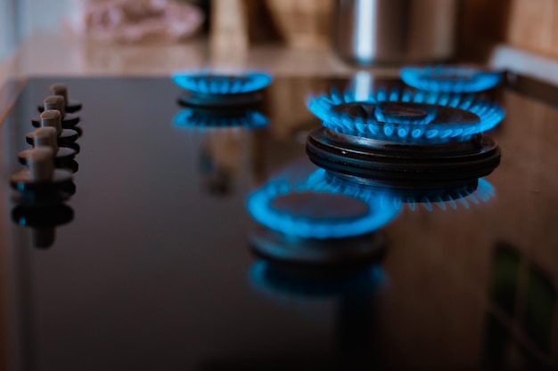 Modern kitchen stove cook with blue flames burning