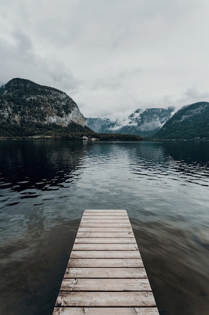 Modern landscape shot of Hallstatt in Austria Lake Hallstatt foggy dramatic mood cloudy travel