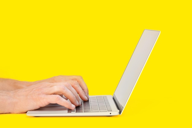 Modern laptop computer on the tabl on the blackboard background