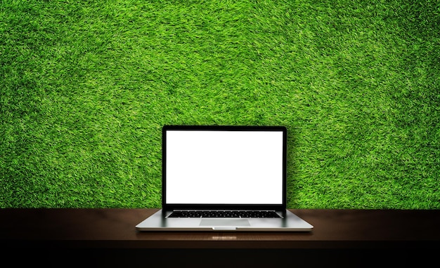 Modern laptop isolated on green grass background 3D illustration