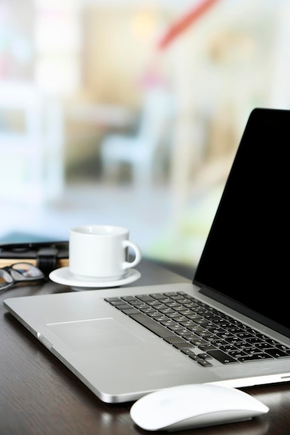 Modern laptop on table on light background