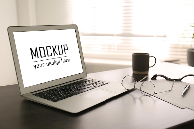 Modern laptop with text Mockup Your Design Here on screen