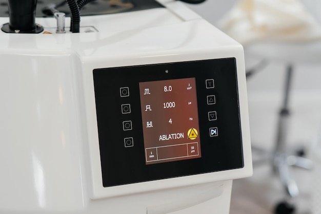 Modern laser in a beauty salon closeup Laser pulses cleanse the skin Hardware cosmetology The process of photothermolysis warming the skin Facial skin rejuvenation