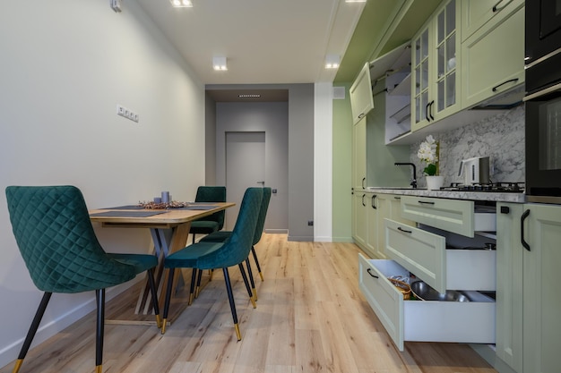 Modern light green luxurious kitchen with dining table