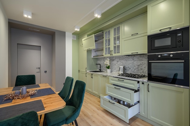 Modern light green luxurious kitchen with dining table