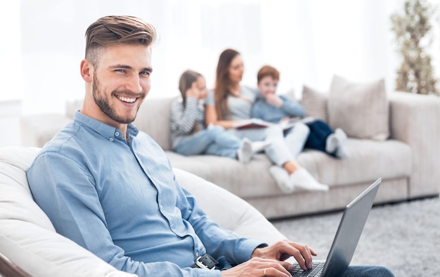 Modern man working laptop in his living room