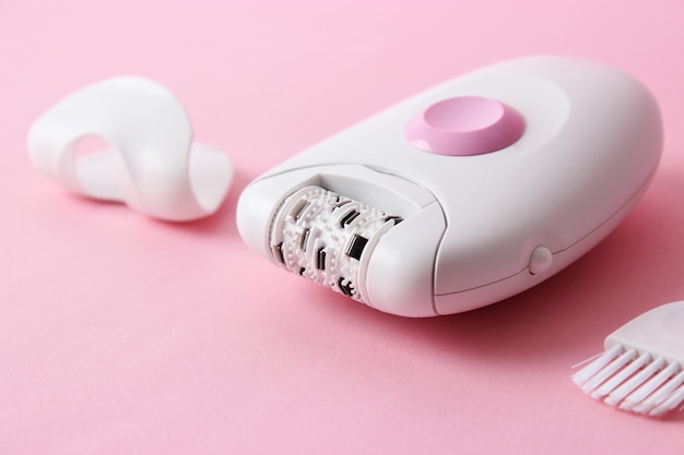 Modern mechanical epilator on a colored background closeup