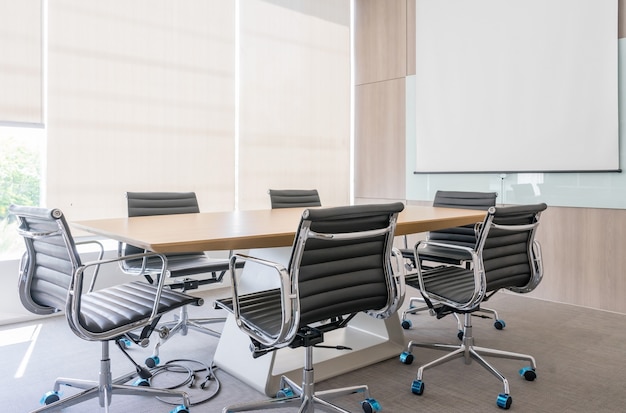 Modern meeting room with projection screen and conference table