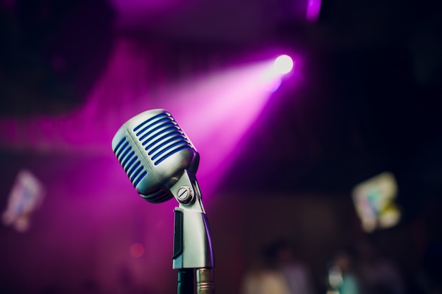 Modern microphone for singing against beautiful blurry colored bokeh.