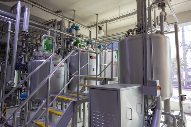 Modern milk cellar with stainless steel tanks for stairway