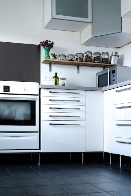 Modern and minimalist kitchen with stove oven cabinet and dark floor