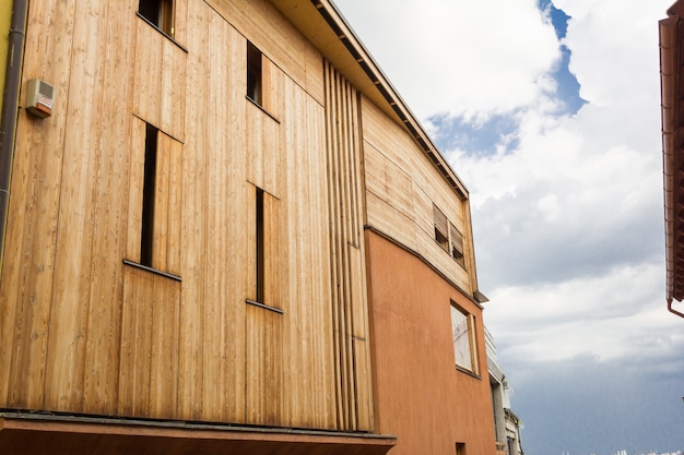 Modern minimalistic style brick house with wooden covering.