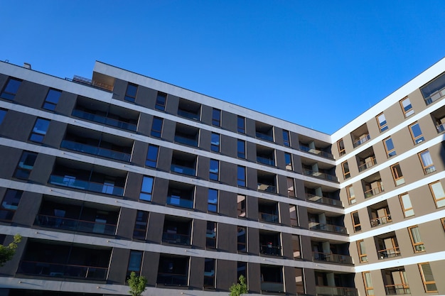 Modern multistorey white and grey residential building with balconies