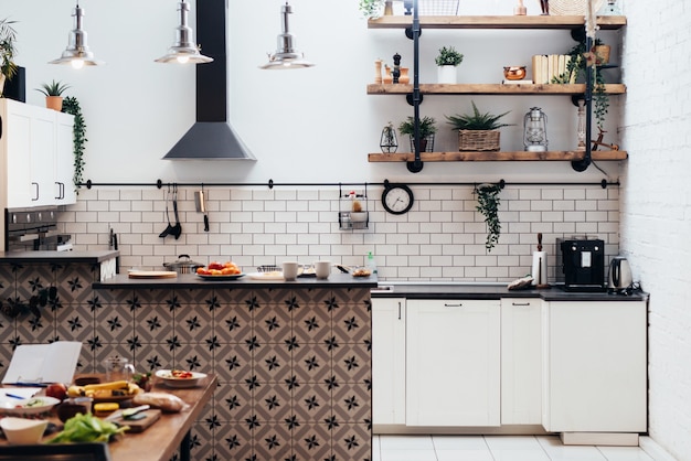 Modern new light interior of kitchen with white furniture.