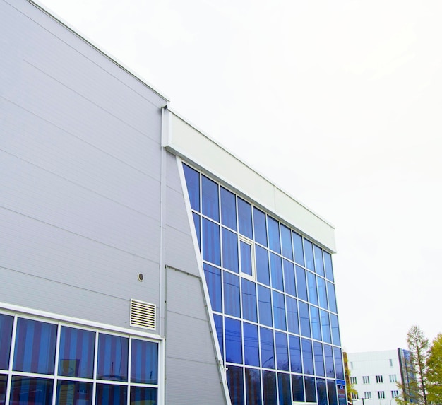 Modern office building with glass wall nearby Parking