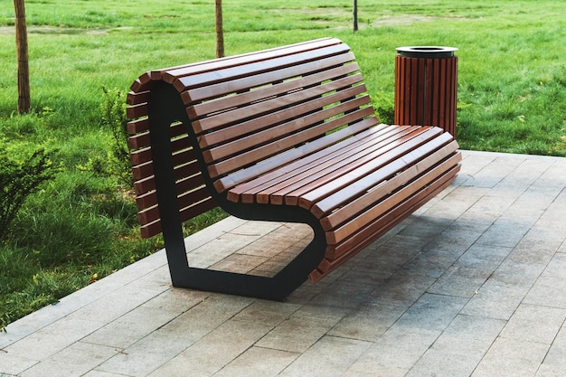 Modern park bench and waste bin made of wooden planks