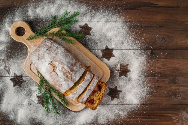 Modern pastries cruffins, like croissant and muffin with sugar powder, served with Christmas decoration and fir-tree