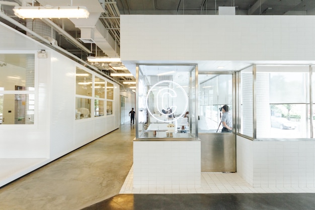 Modern pastry kitchen decorated in white and window glass with production line.