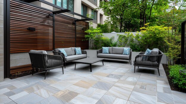 Photo modern patio design with slate tiles wicker furniture and greenery