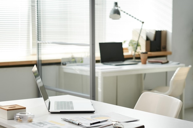 Modern portable computer clipboard with documents on office table in open space office