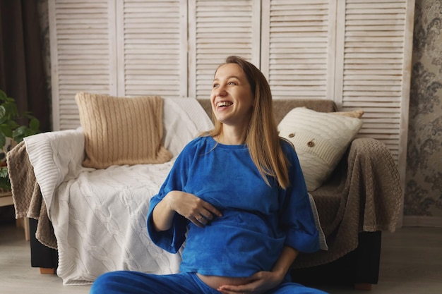 A modern pregnant girl at 30 weeks of pregnancy enjoys pregnancy