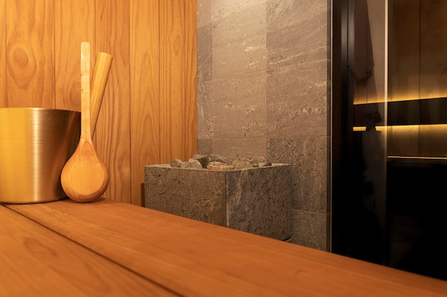 Modern private sauna for one person in apartment.  Interior with elegant stone electric heater, glas