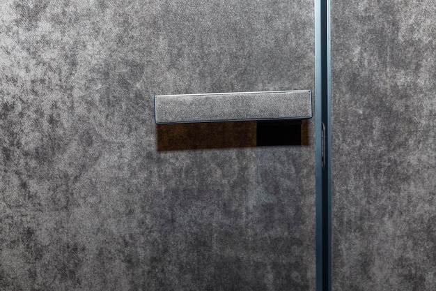 Modern profile door with handle upholstered in gray velor fabric Modern trends in decor and interior design Closeup