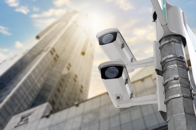 Modern public CCTV camera on electric pole and blur building background with copy space