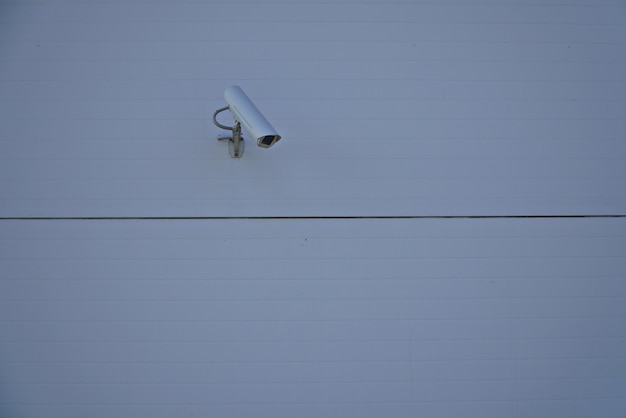 Modern public CCTV camera on wall with blur building background Recording cameras for monitoring all day and night