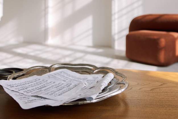 Modern room interior in minimal style Music notes pages scattered on wooden table Morning sun rays with shadow on white background