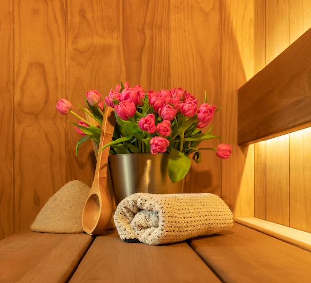 Modern Sauna accessories and bouquet of tulips flowers