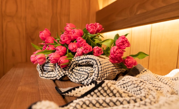 Modern Sauna accessories and bouquet of tulips flowers