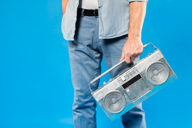 Modern senior man with vintage radio