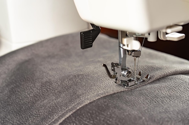 Modern sewing machine and gray fabric Sewing process handmade hobby DIY business repair