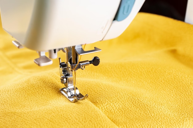 Modern sewing machine and yellow fabric Sewing process handmade hobby DIY business repair