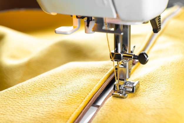 Modern sewing machine and yellow fabric Sewing process handmade hobby DIY business repair