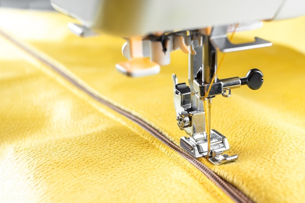 Modern sewing machine and yellow fabric Sewing process handmade hobby DIY business repair