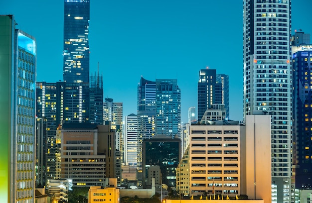 Modern skyscrapers illuminated at night reflecting on facade Bangkok city night view City downtown skyline of Thailand Cityscape Thailand