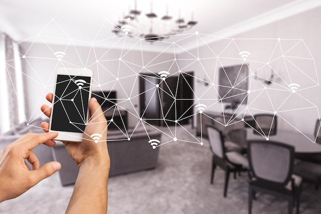 modern smarthome living room controlled by man holding a smartphone            - Image