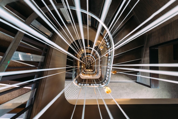 Modern spiral staircase with lights in the middle Optical perspective Stairway in hotel in Paris