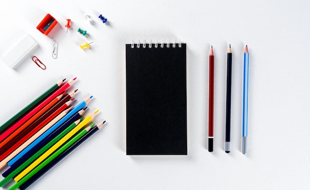 Modern stationery notepad and colour pencil mock-up composition