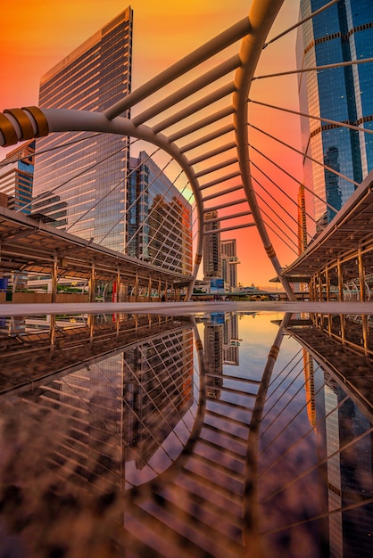 Modern structure bridge shape and building at sunset in train station, Bangkok, Thailand.