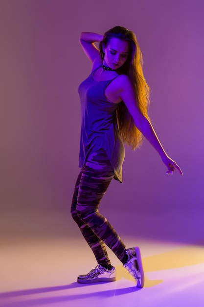 Modern style dancer posing on studio background. Color filters